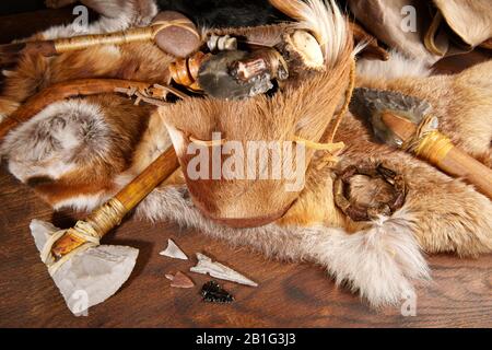 Stone Age Tools on wooden Background Stock Photo