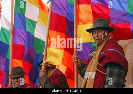 Several Aymara Indians carry the Wipala, the original flag of the Andean indigenous peoples Stock Photo