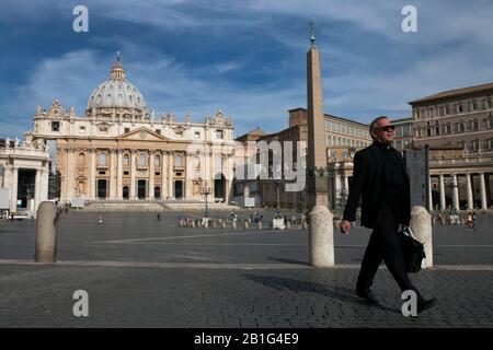 A priest walks through St. Peter's Square Stock Photo