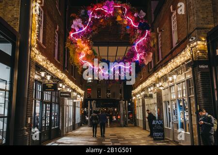 London, UK - November 29, 2019: People walk under Christmas in Spitalfields Market, one of the finest Victorian Market Halls in London with stalls off Stock Photo