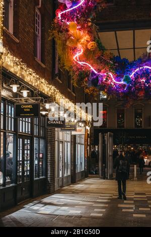 London, UK - November 29, 2019: Man walks under Christmas in Spitalfields Market, one of the finest Victorian Market Halls in London with stalls offer Stock Photo