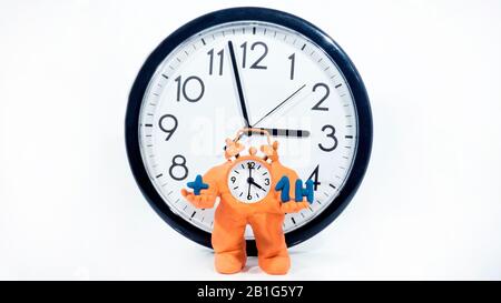 Funny ClockMan made from Play Clay. Isolated on white background. Daylight Saving Time Concept. Stock Photo