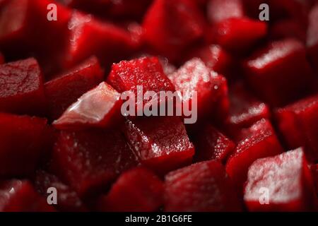Small square raw beetroot slices background. Healthy vegan food. Stock Photo