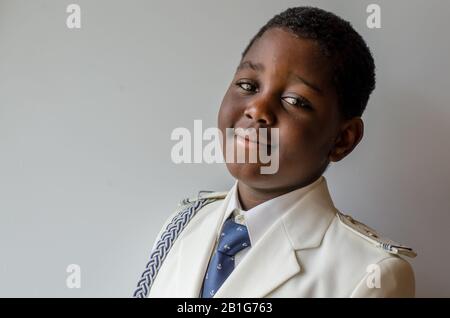 Portrait of black child dressed in first communion Stock Photo