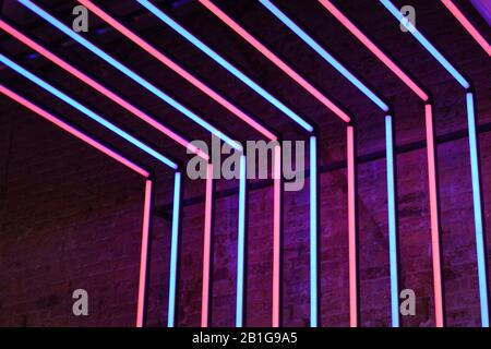 Neon red and blue lights stone wall background Stock Photo