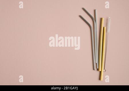Different eco-friendly drinking straws set. Stainless steel metal, bamboo, glass reusable drinking straws. Flat lay, top view. Zero waste, plastic fre Stock Photo
