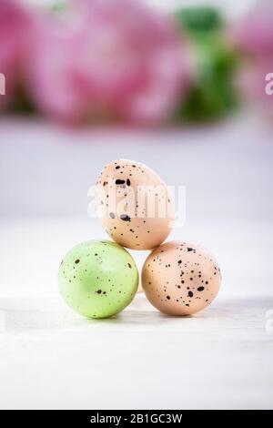 Happy Easter. Three pastel Easter eggs on a white background, copy space Stock Photo