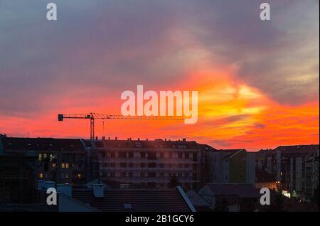 Construction site at sunset shot from window. Housing, brick.  - image Stock Photo