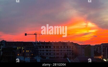 Construction site at sunset shot from window. Housing, brick.  - image Stock Photo