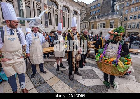 London, UK. 25th February 2020. The City of London's Livery companies take part in the Inter-Livery pancake races in Guildhall Yard, a tradition begun by the Worshipful Company of Poulterers in 2005 supporting the Lord Mayor's Charity. Poulterers supply eggs for the pancakes, Clockmakers time the races, Gunmakers fire a starting gun and Fruiterers provide the lemons. As well as competitions for Masters and members of the companies there is also a fancy dress class, with some interesting contributions reflecting the livery companies and the charity. Peter Marshall/Alamy Live News Stock Photo