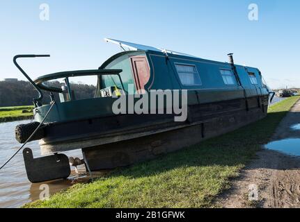 A narrowboat left on the canal bank after flooding during Storm Dennis, February 2020 Stock Photo