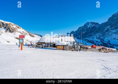 GRINDELWALD-FIRST, SWITZERLAND - JANUARY 15 2020: People enjoy winter sports on The First mountain in Swiss Alps in a popular Jungfrau Region Stock Photo