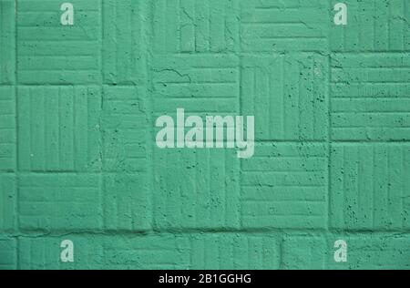 Decorative green painted wall with square and strips background texture. Stock Photo
