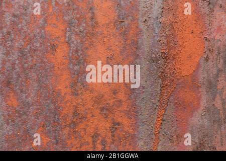 Rusty metal wall, old sheet of iron covered with rust with paint background texture. Stock Photo