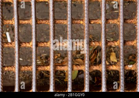 Mesh fence background.Grid iron grates, Grid pattern, steel wire mesh fence wall background, Chain Link Fence with brown Background. Stock Photo