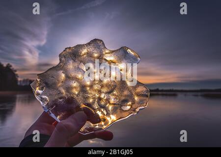 The piece of ice in the hand Stock Photo