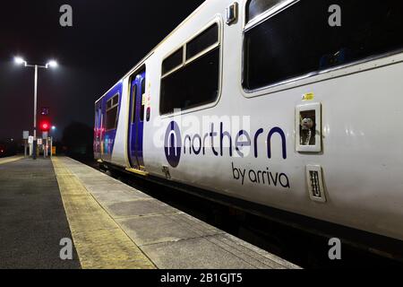 Arriva Northern rail logo on a class 150 sprinter train with a red railway signal Stock Photo