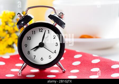 Spring Time Change Background with alarm clock and flower branches Stock Photo
