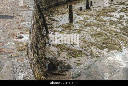 Watchet, Somerset, The low tide blocks the fishermen's ships in the port of Watchet, exposing the shallow muddy bottom summer 2019 Stock Photo