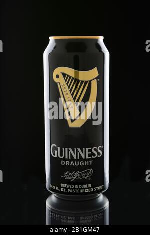 IRVINE, CA - JANUARY 11, 2015: A can of Guinness Draught on black. Guinness has been producing beer in Ireland since 1759, and is one of the most succ Stock Photo