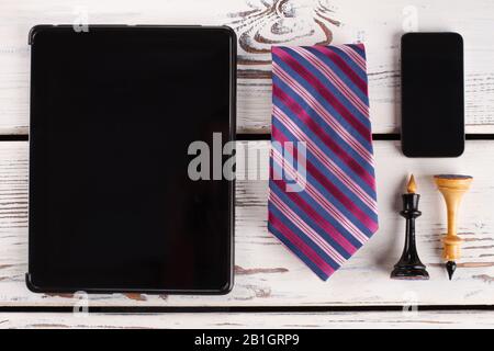 Chess figures, tie and devices. Stock Photo