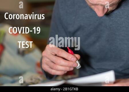 Text CORONAVIRUS COVID-19 TEST. Testing for Coronavirus at home. Test system to identify virus in sputum. male father holding test tube with tests aga Stock Photo