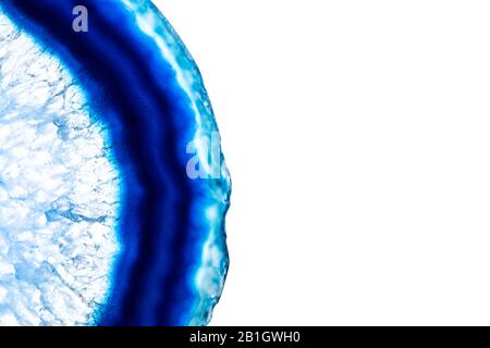 Blue agate slice stone with details of pattern isolated on white background with copy space for text. Stock Photo