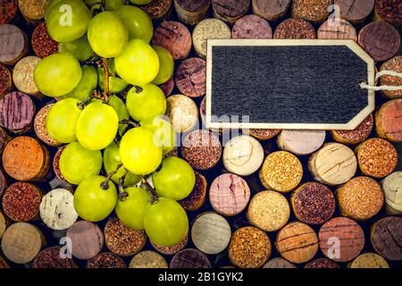 Full  frame with wine corks, graps  and a blackboard for individual text Stock Photo