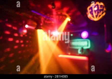 Blurred disco club with original laser color lights and disco ball - Defocused image - Concept of nightlife with cocktails, music, entertainment - War Stock Photo