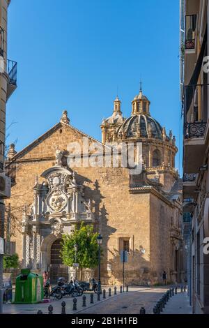 Granada, Spain - January 6, 2020: View of the building of the Basilica of Saints Justus and Pastor with street view, Andalusia. Vertical