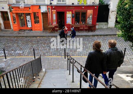 Pedestrians walking down the steep street on Montmartre.Paris.France Stock Photo