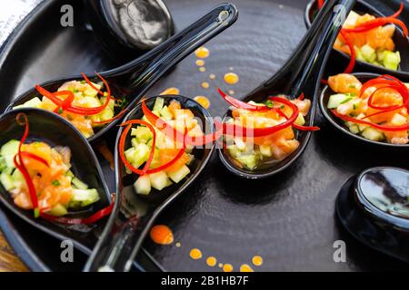 Traditional Japanese food - Salmon sashimi in modern style of eating. Stock Photo