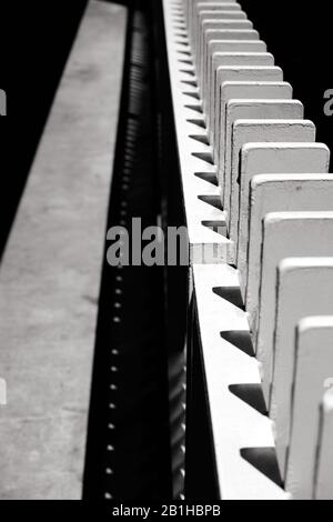 Vertical view of structural elements looking like dominoes lined up along pathway Stock Photo