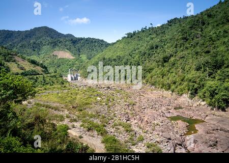 Small hydroelectric dam in Quang Tri province, Vietnam with dry river in summer Stock Photo