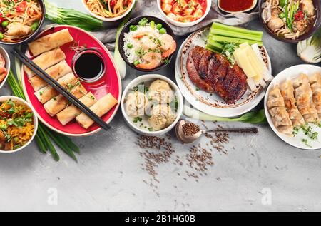 Assorted Chinese dishes on grey background.  Asian food concept. Top view with copy space Stock Photo