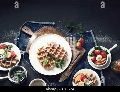 Traditional belgian waffles with fresh berries and fruits for breakfast. Top view with copy space Stock Photo