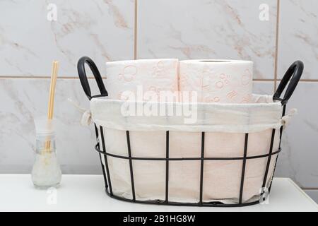 Soft toilet paper rolls in a vintage basket Stock Photo