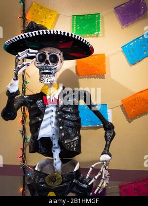 Traditional mexican skeleton sculpture with Mariachi outfit and Sombrero in market alleyway celebrating Dios de los Muertos in San Antonio, Texas. Col Stock Photo