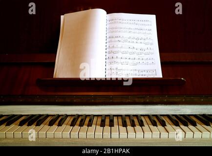 Vintage Piano with a Music Book Stock Photo