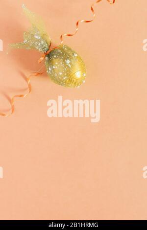 Easter egg and festive ribbon on the colorful background. View from above. Top view. Flat lay image of easter festive holiday background. Concept of Stock Photo