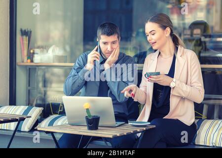 Successful business partners remote working at cafe terrace Stock Photo