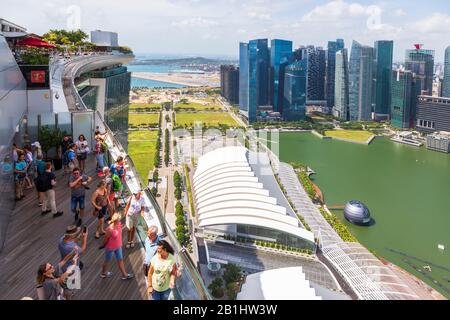 Tourists on the observation deck of the Marina Bay Sands hotel overlooking Marina Bay towards the business district of Singapore, Asia Stock Photo