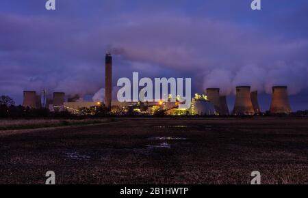 Drax, North Yorkshire. Evening falls on the rural village of Drax with the twinkling lights of a local Power Station and water vapour emitting from th