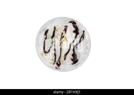 four balls Ice cream dessert, vanilla flavor, with chocolate topping, isolated on a white background in creamer on a plate with a spoon and a napkin, Stock Photo