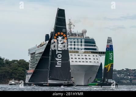 Tom Slingsby’s Australia SailGP Team sails close to the Celebrity Solstice cruise ship and the InfoTrack yacht, the same yacht which Tom Slingsby skippered in the 2017 Sydney Hobart Yacht Race. Sydney SailGP, Event 1 Season 2 in Sydney Harbour, Sydney, Australia. Stock Photo