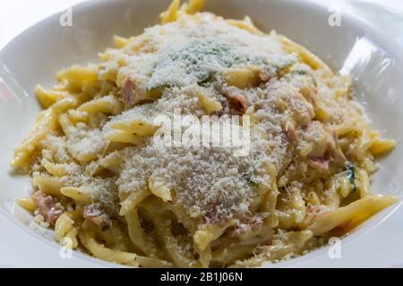 Plate of pasta carbonara with bacon and parmesan cheese in Vaduz, Liechtenstein. Stock Photo