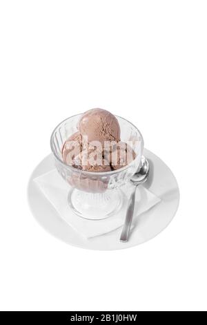 four balls Ice cream dessert, chocolate flavor, isolated on a white background in creamer on a plate with a spoon and a napkin, side view for menu Stock Photo