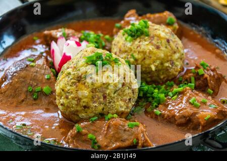 Goulash stew with two Tyrolean bread dumplings, in South Tyrol, Italy. Stock Photo