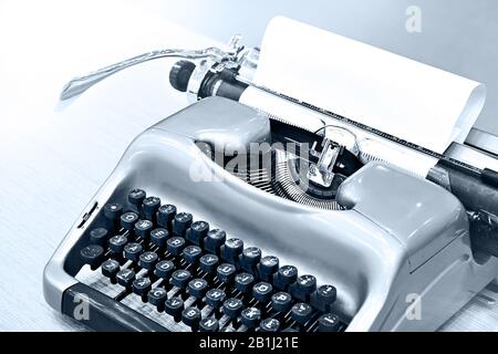 Green retro typewriter on wooden table Stock Photo