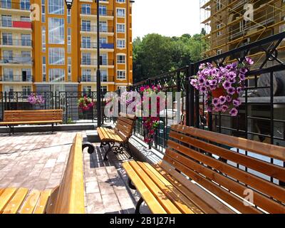 Kiev, Ukraine – June 12, 2018: Benches with flowers on the top resting area. The new colorful quarter 'Vozdvizhenka' with new houses